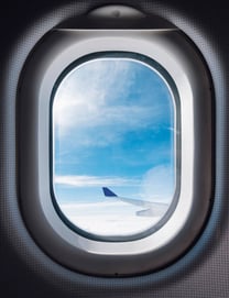jpeg-optimizer_airplane-window-with-blue-sky-wing 1